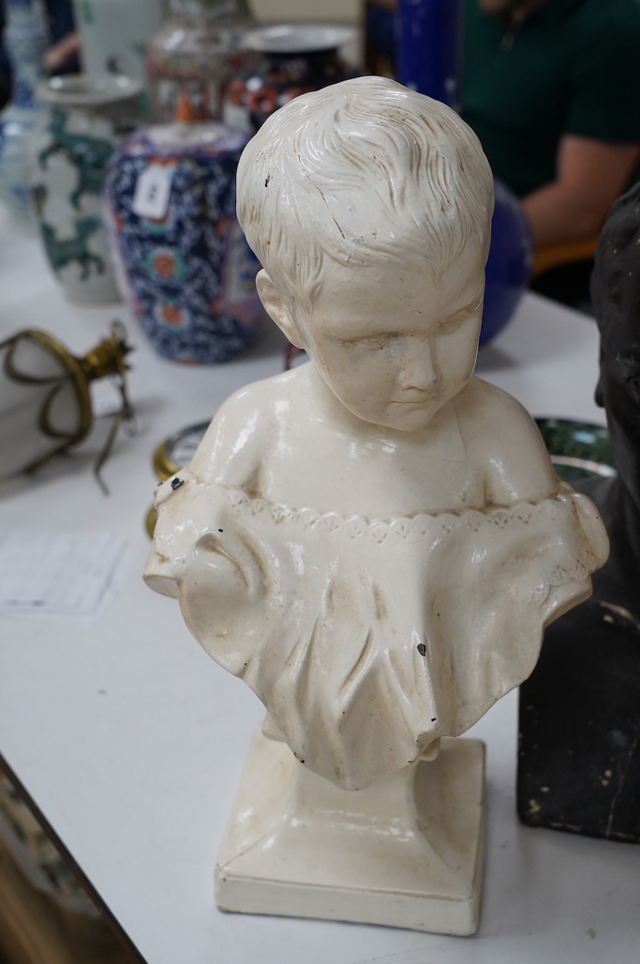 Three decorative plaster busts; the Duke of Wellington, 60cm high, another male figure, and a child. Condition - poor